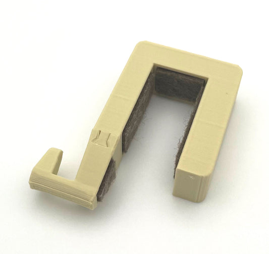 Gesamtansicht des Aufsteckhakens für Schrank- und Badtüren im Eriba Touring, Troll oder Puck.
Zu sehen ist die beige Variante. Gut zu erkennen ist die Filzeinlage, die das Holzdekor der Türen von Kratzern schützen soll. 